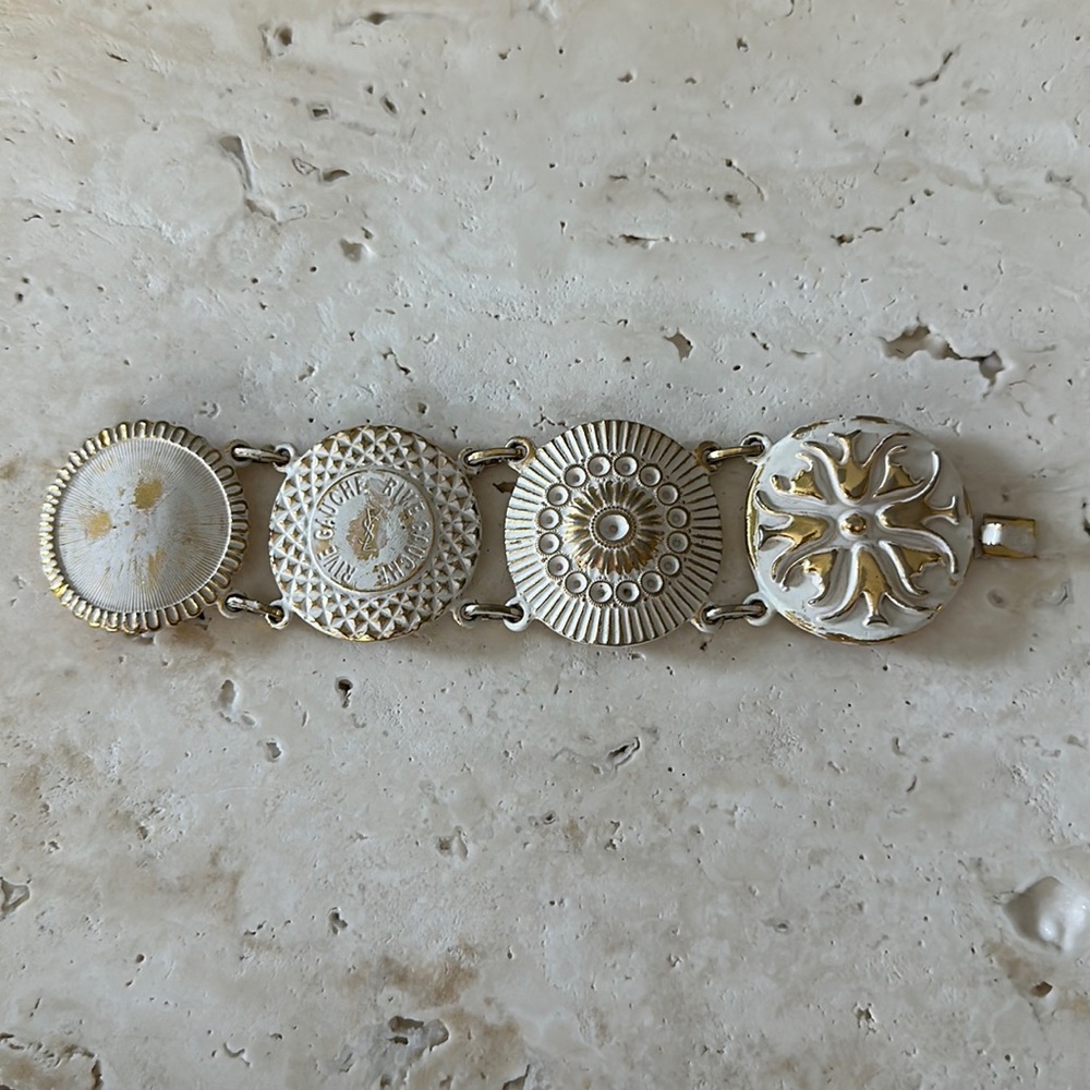 YSL Yves Saint Laurnet four disc enamel white and gold bracelet w original box.